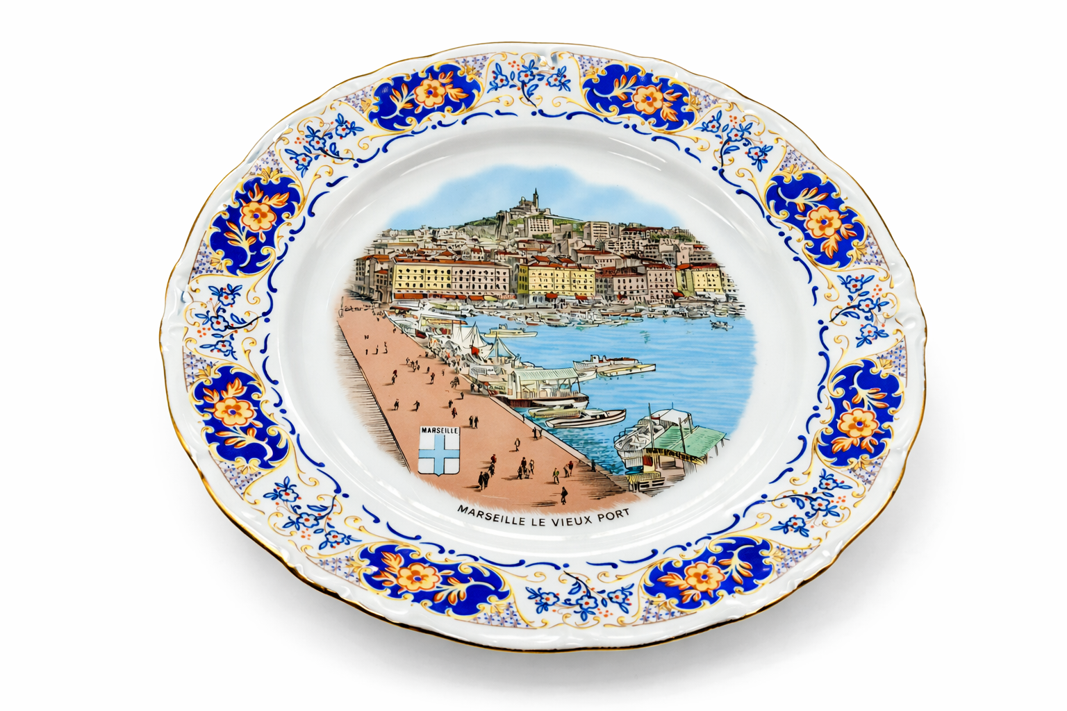 Assiette ancienne en porcelaine décor Marseille le Vieux-Port, vue inclinée mettant en valeur la bordure florale bleue et or