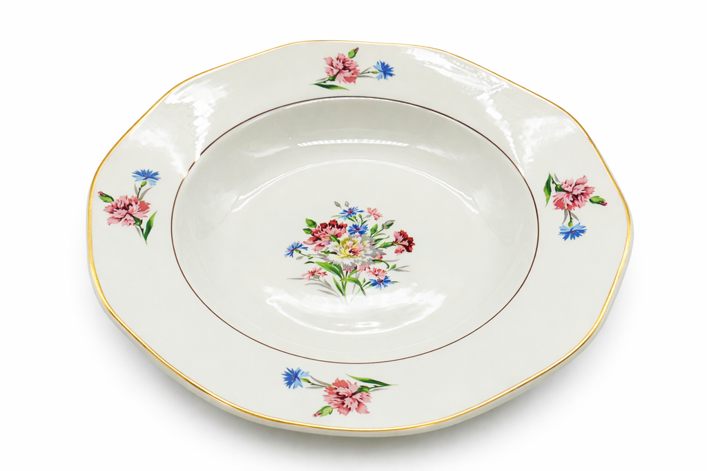 Assiette creuse ancienne en faïence fine, décor floral peint au centre, motifs floraux répartis et liseré doré sur le bord